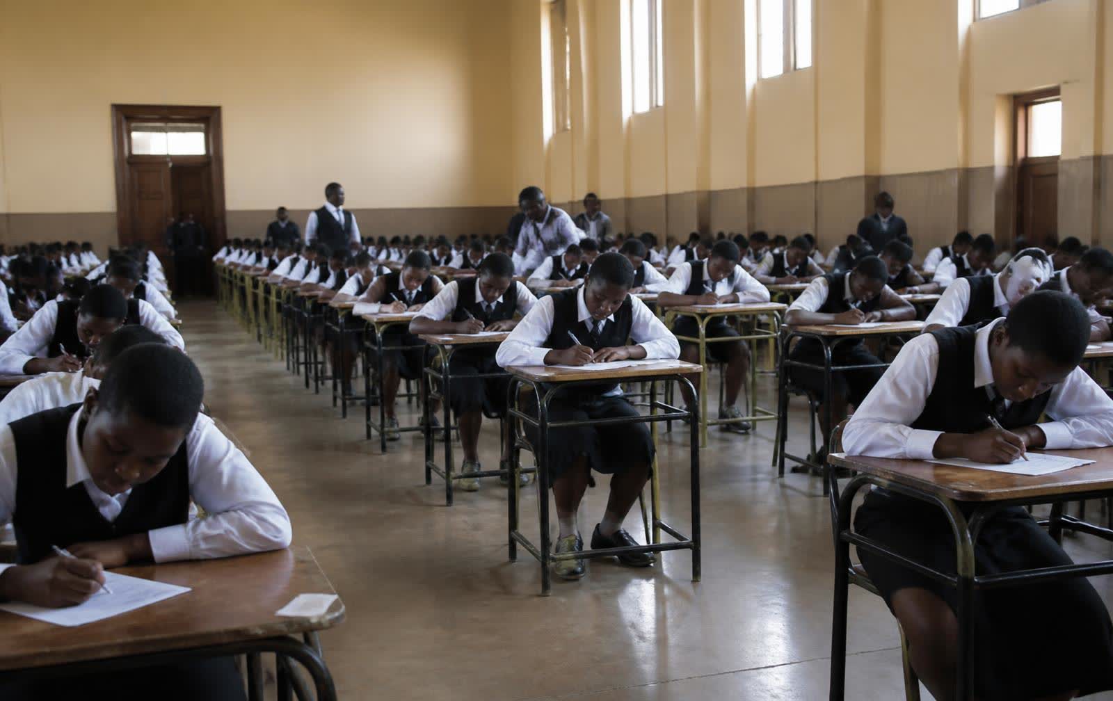 Students writing examinations in a school hall